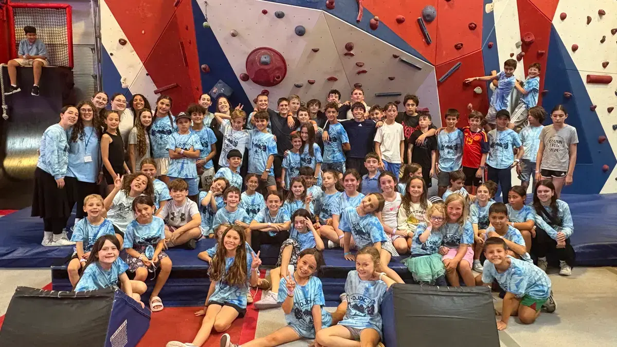 The whole camp gathered on the bleachers at the climbing gym
