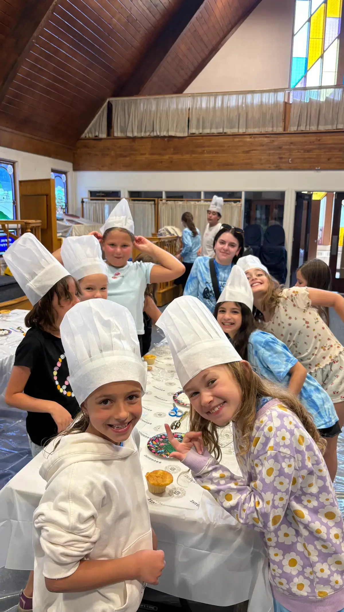 Campers in white chef hats at the cooking workshop