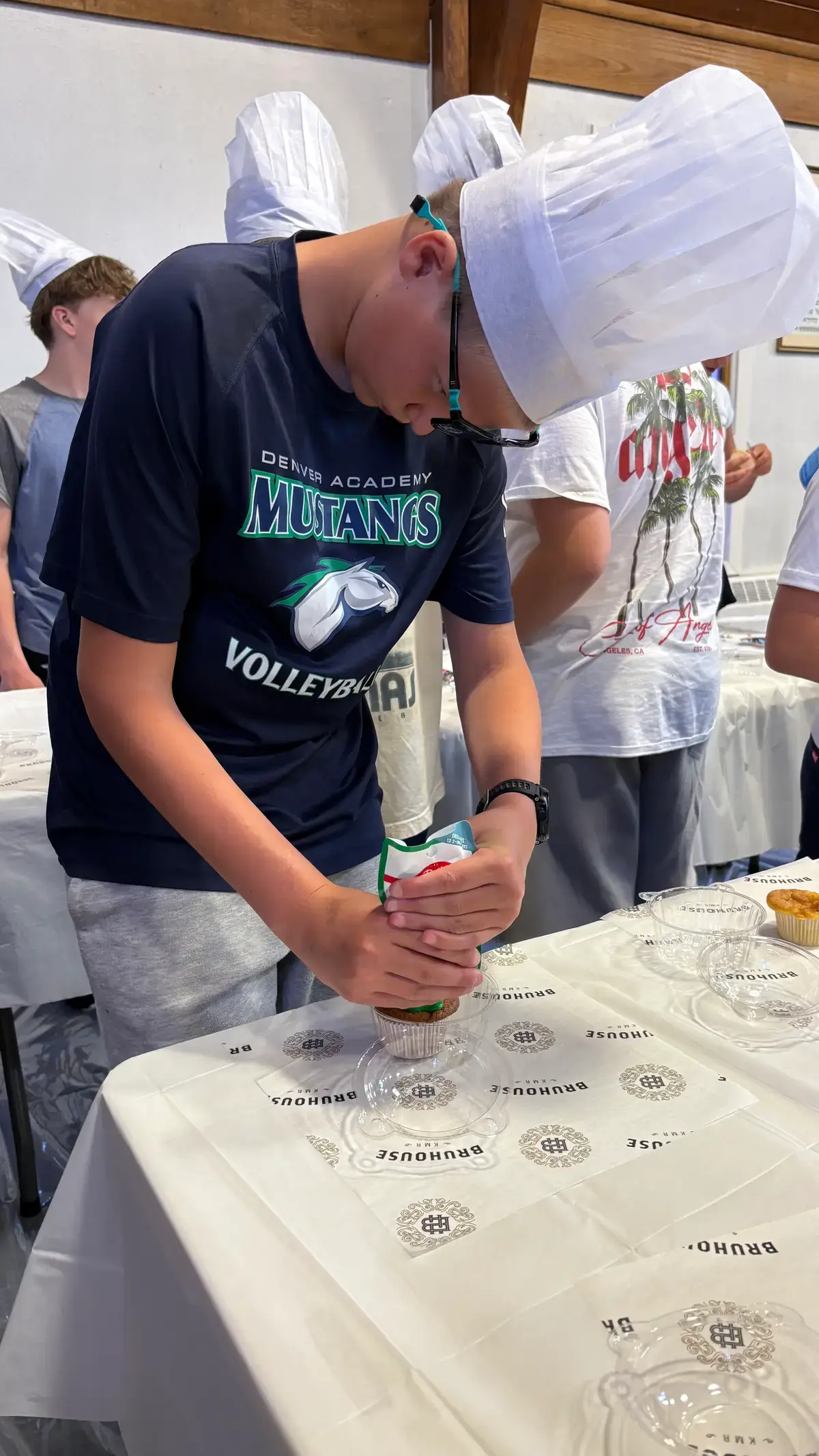 A camper kneading challah dough up close