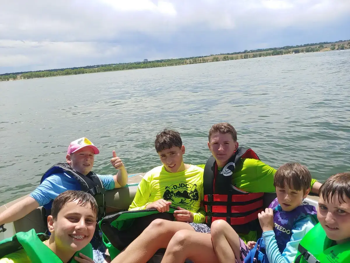 Campers in life jackets out on the lake