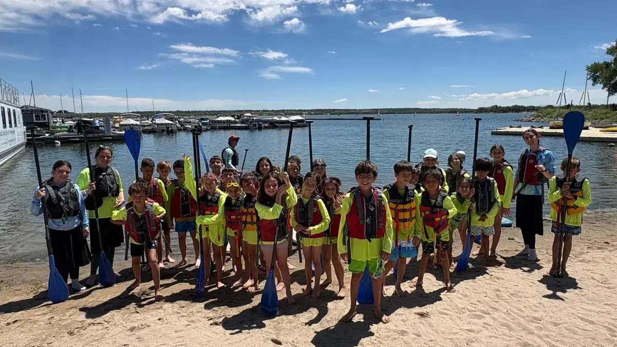 Campers in life jackets lined up at the marina