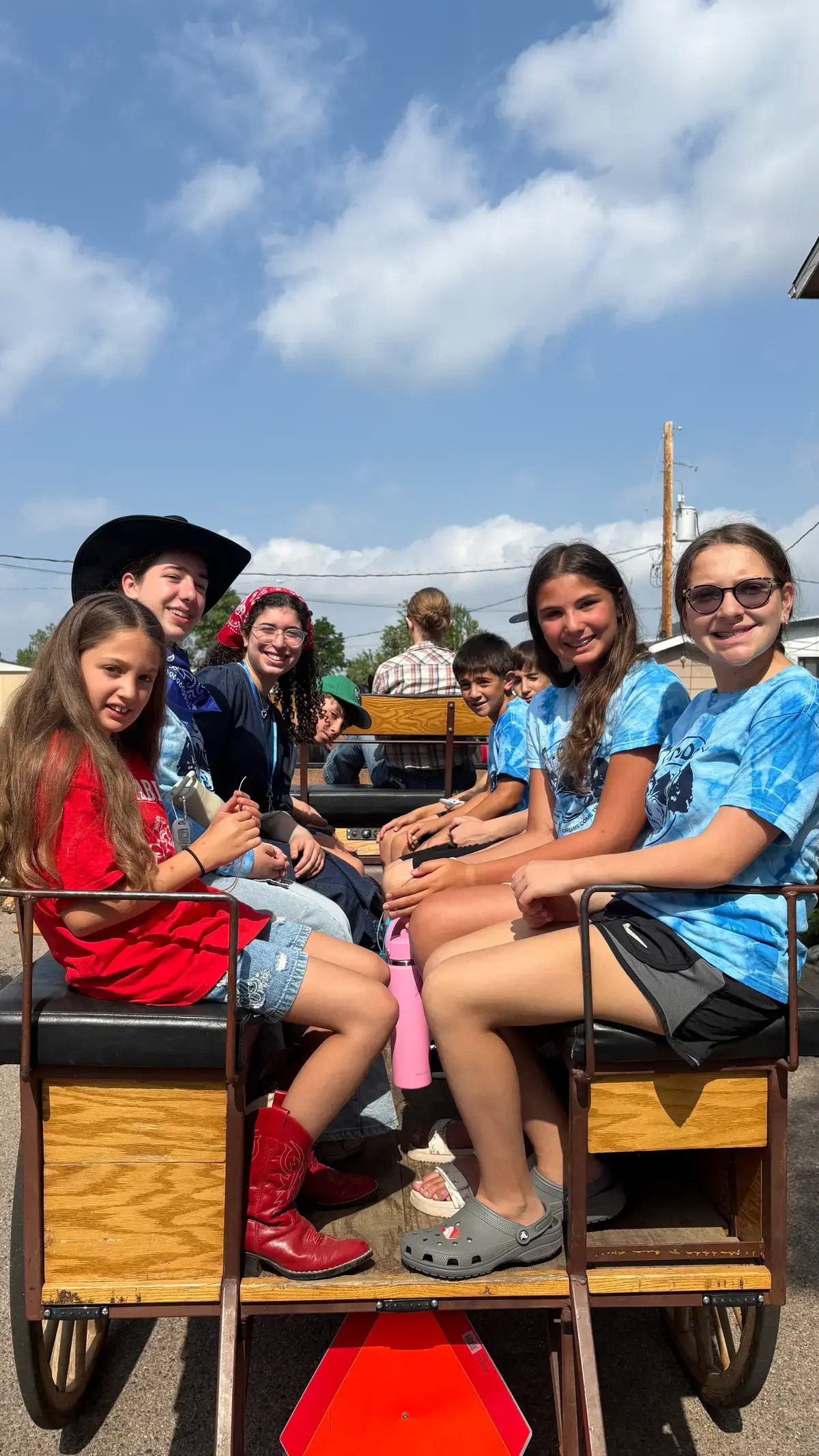 Campers riding a wagon on a farm trip